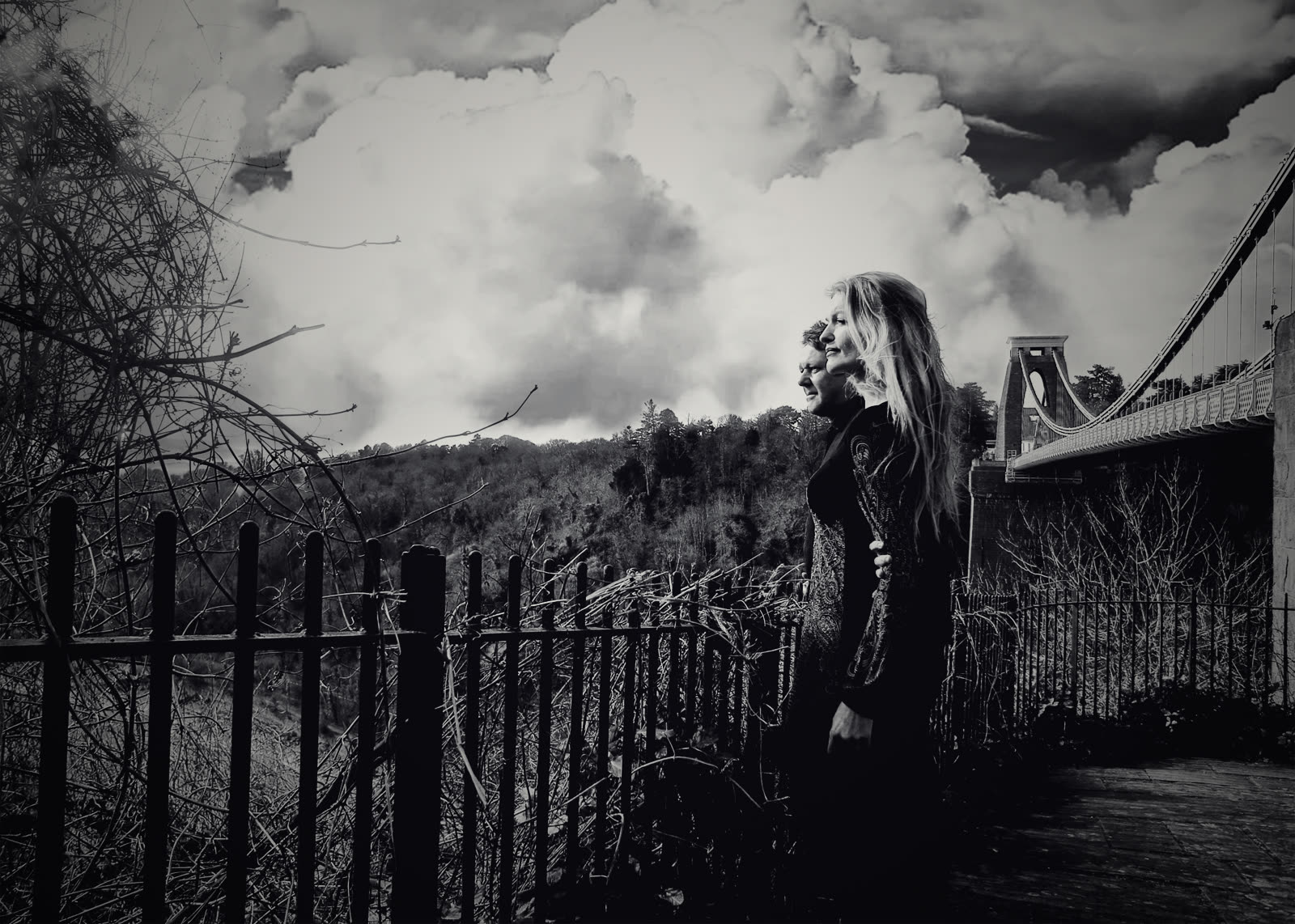 Sophie and Jonny by the railings at Clifton, the suspension bridge behind them